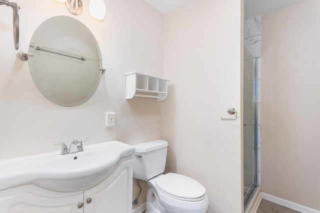 bathroom featuring toilet, vanity, and walk in shower