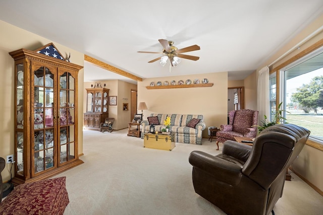 carpeted living room featuring ceiling fan