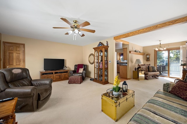 living room with ceiling fan with notable chandelier and light colored carpet