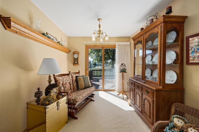 sitting room featuring light carpet and a chandelier