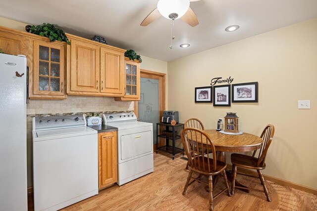 laundry area featuring light hardwood / wood-style flooring, cabinets, separate washer and dryer, and ceiling fan