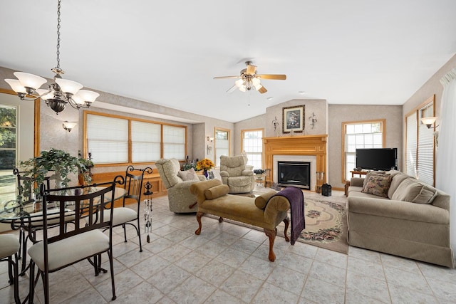 living room featuring lofted ceiling and ceiling fan with notable chandelier