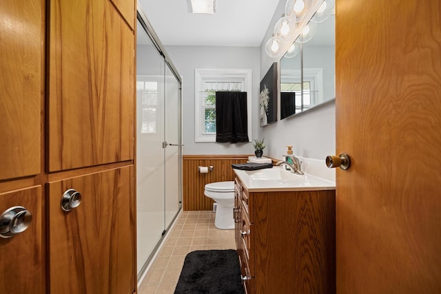 bathroom featuring vanity, wooden walls, toilet, and an enclosed shower