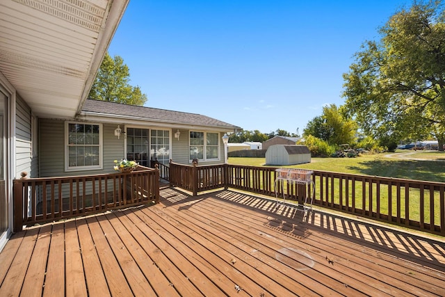 deck with a yard and a shed