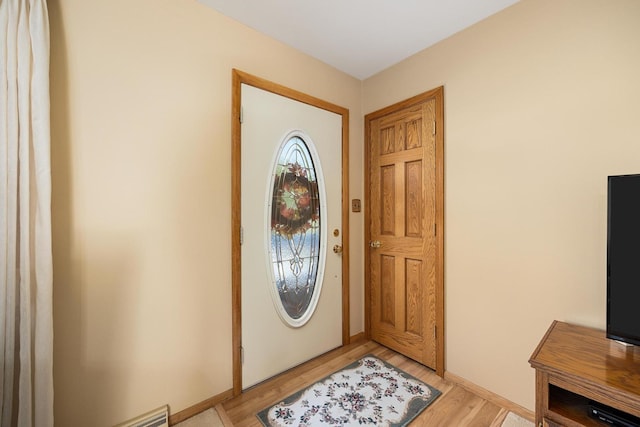 foyer entrance with light hardwood / wood-style floors