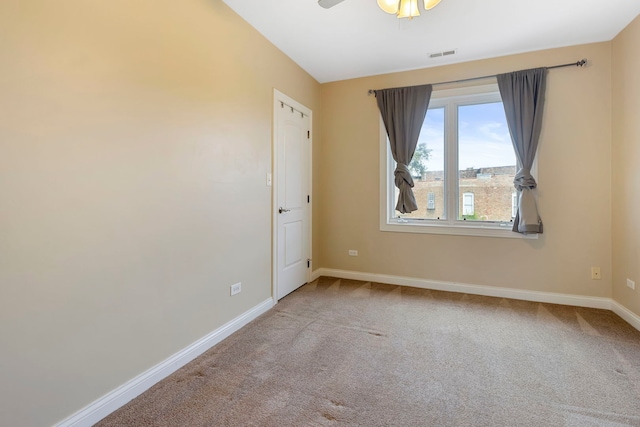 carpeted empty room featuring ceiling fan