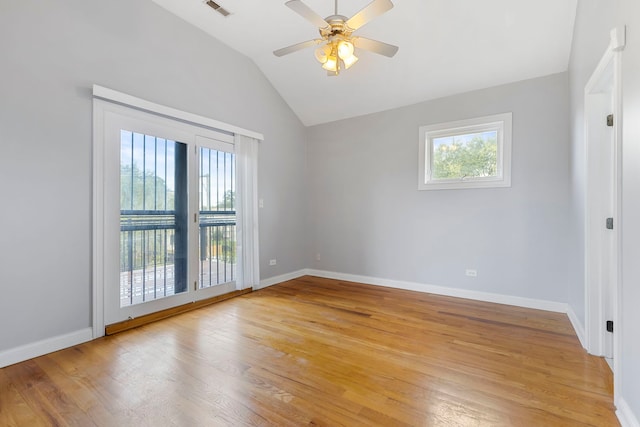 empty room with light hardwood / wood-style flooring, lofted ceiling, and ceiling fan