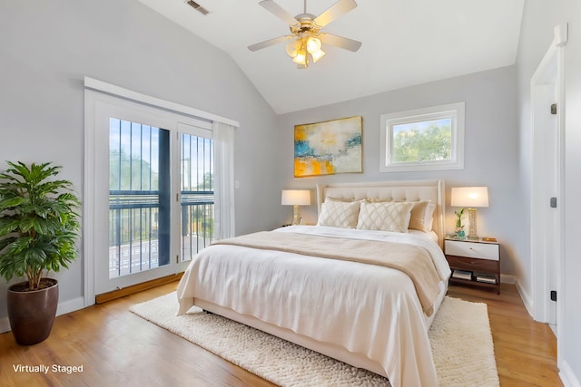 bedroom featuring hardwood / wood-style floors, access to exterior, ceiling fan, and vaulted ceiling