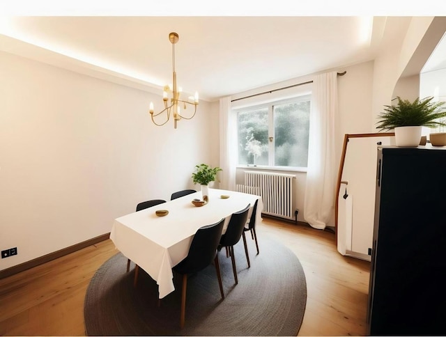 dining area featuring radiator, a chandelier, and light wood-type flooring