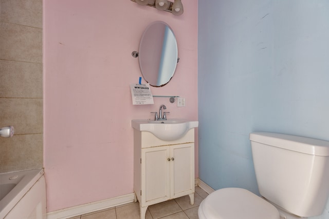 bathroom featuring a washtub, tile patterned floors, vanity, and toilet