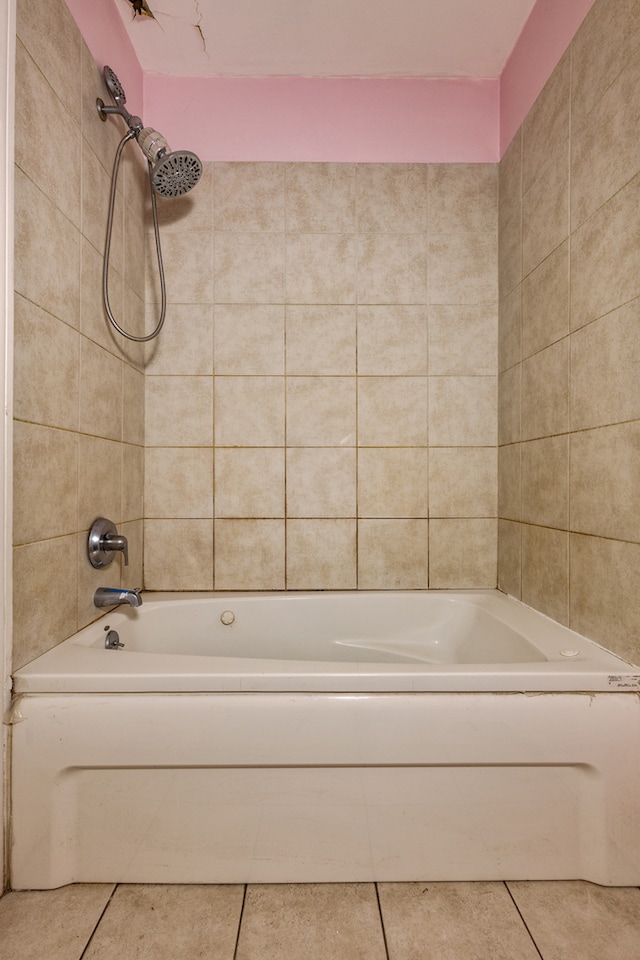 bathroom featuring tile patterned flooring and tiled shower / bath