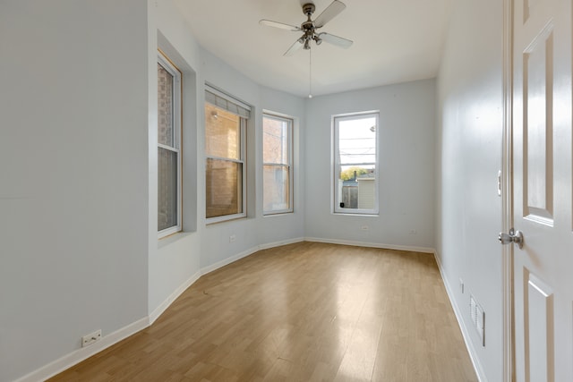 spare room with light wood-type flooring and ceiling fan