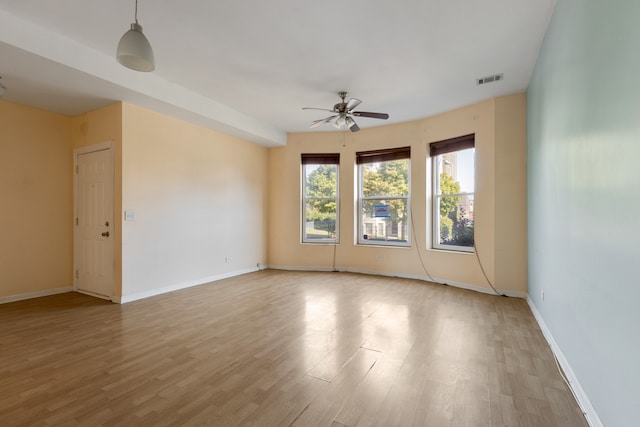 empty room featuring ceiling fan and light hardwood / wood-style floors