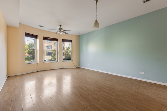 empty room featuring hardwood / wood-style flooring and ceiling fan