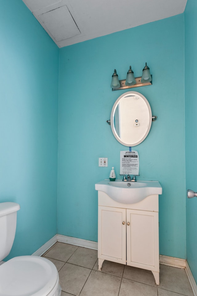 bathroom featuring tile patterned floors, vanity, and toilet