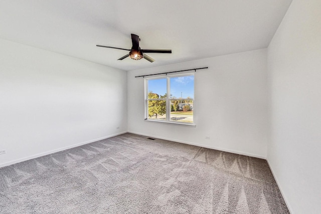 spare room with ceiling fan and carpet