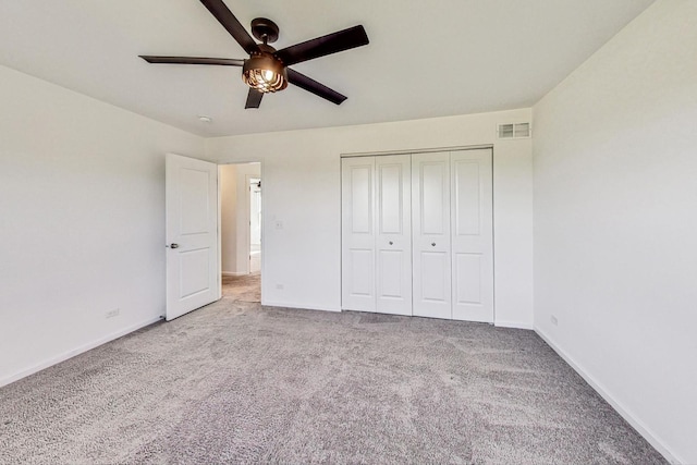 unfurnished bedroom featuring a closet, ceiling fan, and carpet