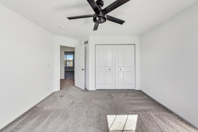 unfurnished bedroom featuring light carpet, a closet, and ceiling fan