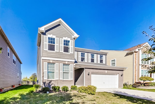 view of front of property featuring a front lawn and a garage