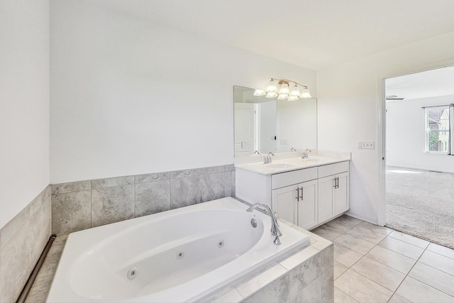 bathroom with vanity, a relaxing tiled tub, and tile patterned floors