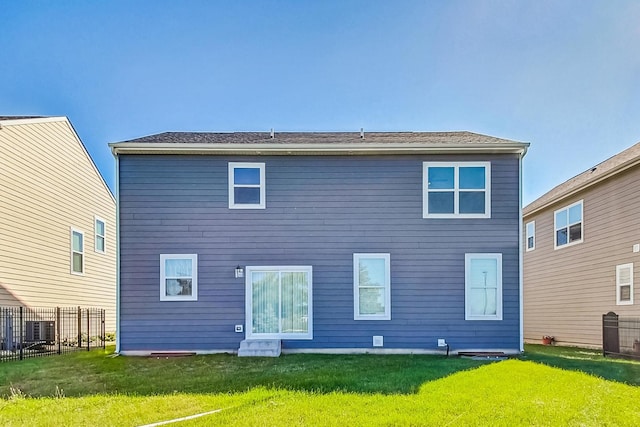 rear view of house with a yard