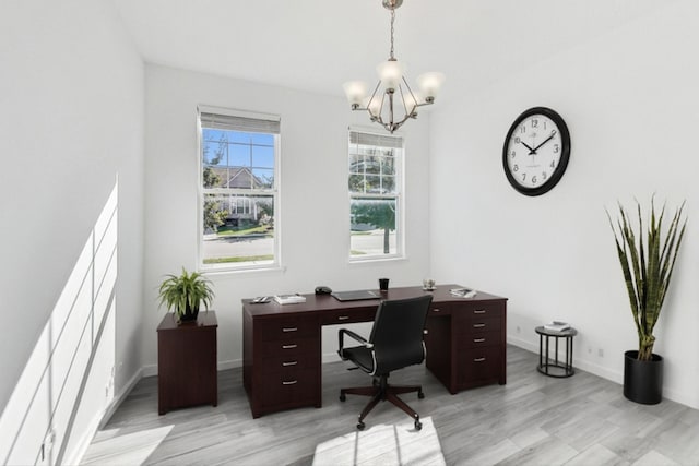 office featuring light hardwood / wood-style flooring and an inviting chandelier