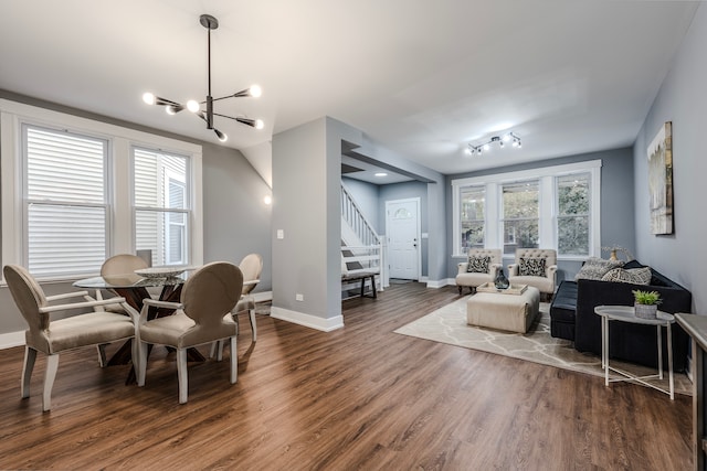 dining room featuring an inviting chandelier, dark hardwood / wood-style floors, and a healthy amount of sunlight