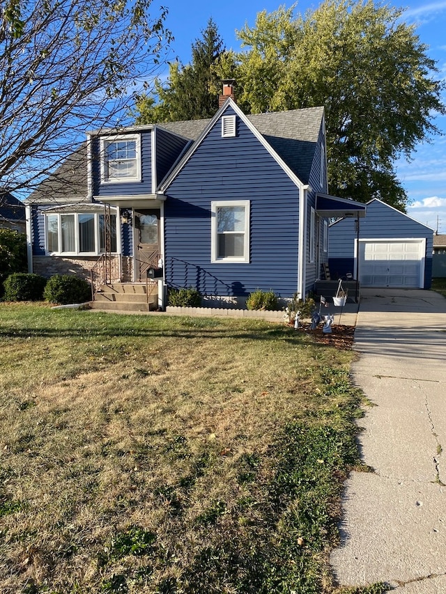 view of front of home with a garage, an outbuilding, and a front yard