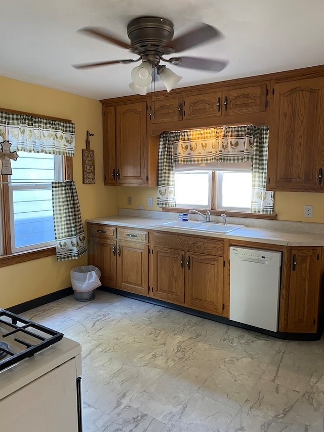 kitchen featuring dishwasher, ceiling fan, and sink