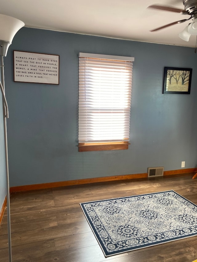 spare room with ceiling fan and dark hardwood / wood-style floors