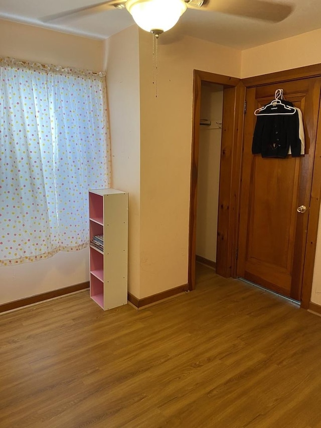 unfurnished bedroom with ceiling fan, a closet, and light hardwood / wood-style floors