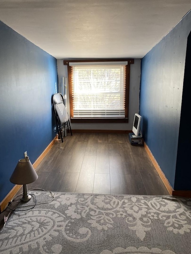 unfurnished room with dark wood-type flooring