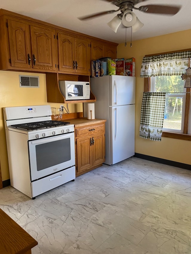 kitchen featuring ceiling fan and white appliances