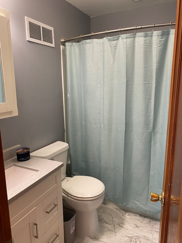 bathroom with walk in shower, vanity, and toilet