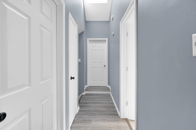 hall with light hardwood / wood-style floors