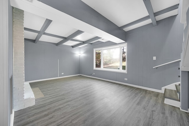 unfurnished living room with coffered ceiling, beamed ceiling, and hardwood / wood-style floors