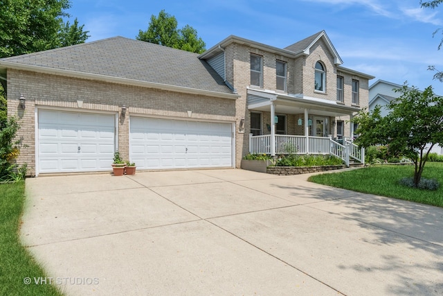 view of front of home featuring a porch and a garage