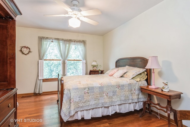 bedroom with hardwood / wood-style flooring and ceiling fan