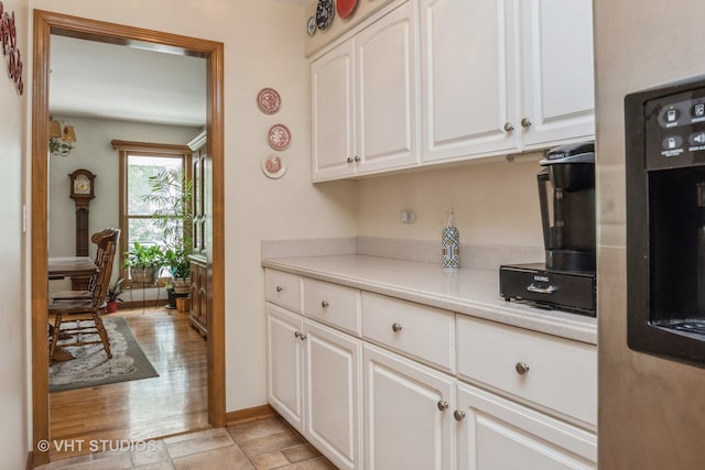 kitchen featuring light hardwood / wood-style flooring and white cabinetry