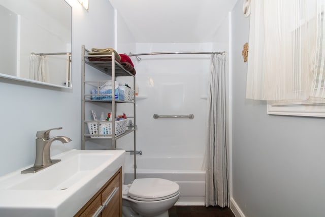 full bathroom featuring vanity, shower / tub combo with curtain, and toilet