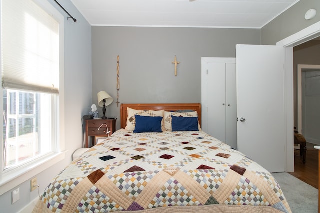 bedroom featuring crown molding and carpet flooring