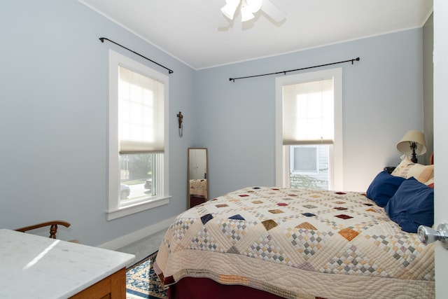 bedroom with ornamental molding, carpet flooring, and ceiling fan