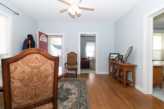 bedroom featuring wood-type flooring, ensuite bathroom, and ceiling fan