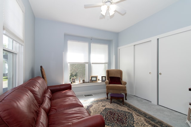 carpeted living room featuring ceiling fan