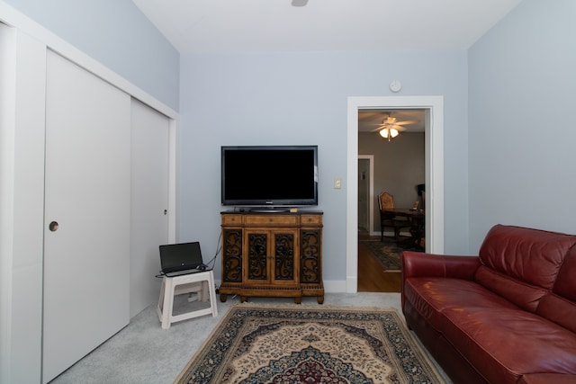 living room featuring ceiling fan and light carpet