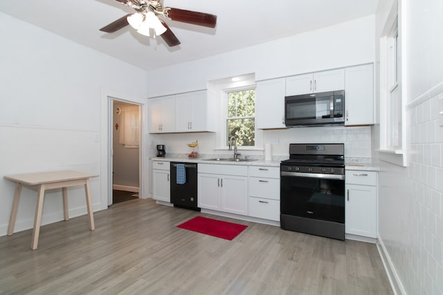 kitchen with ceiling fan, white cabinets, sink, appliances with stainless steel finishes, and light hardwood / wood-style floors