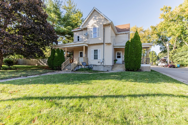 view of front of house with a front yard and a porch