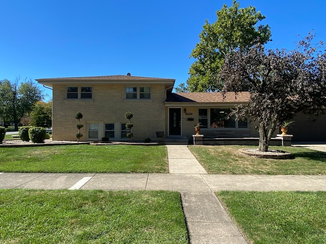 tri-level home with a front yard