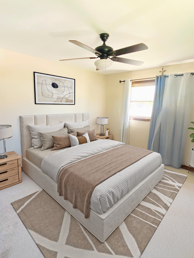 bedroom with ceiling fan and light colored carpet