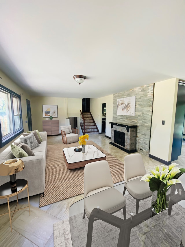 living room with a tile fireplace